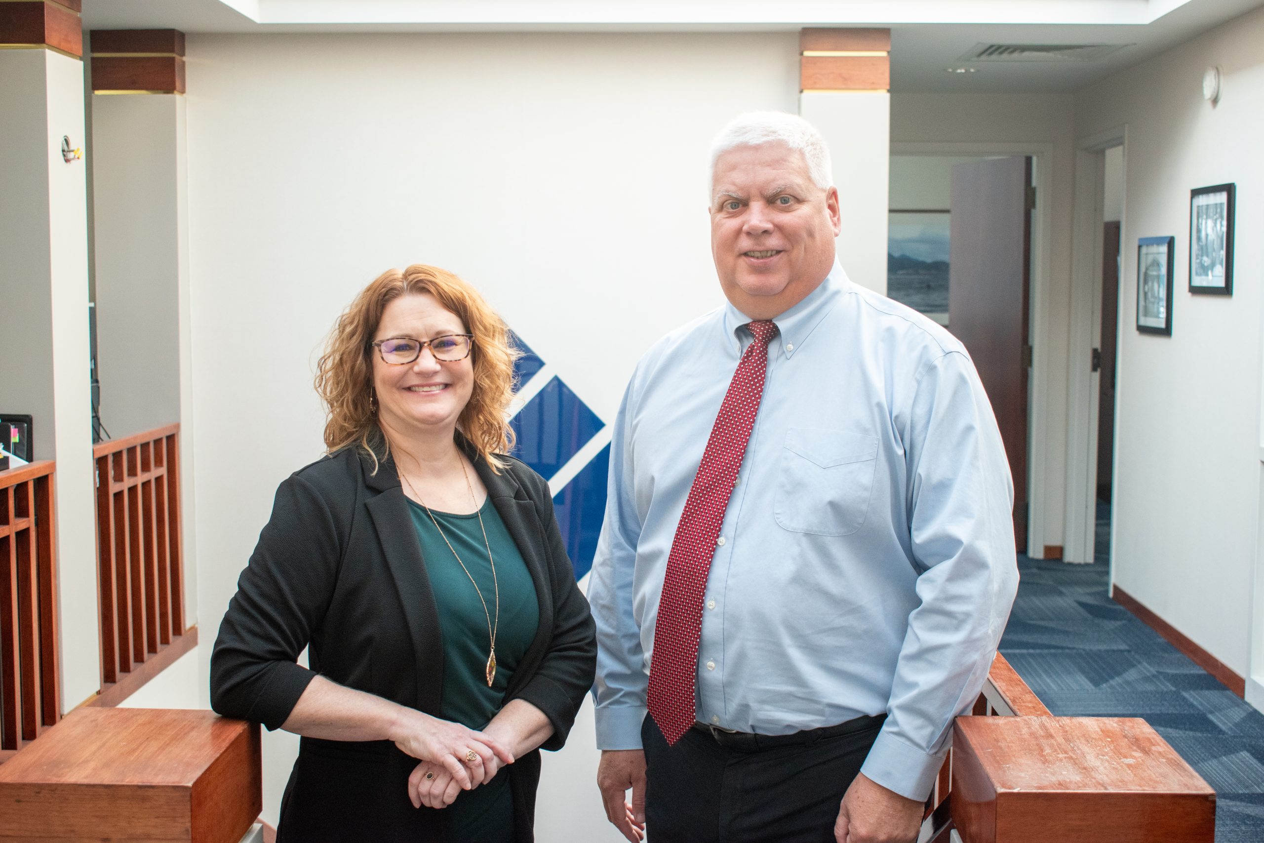 Roger Krabbe, Director of Trust & Wealth Management, and Denise Delacruz, Trust Officer, standing together in the Litchfield, IL office of Bank & Trust Company.