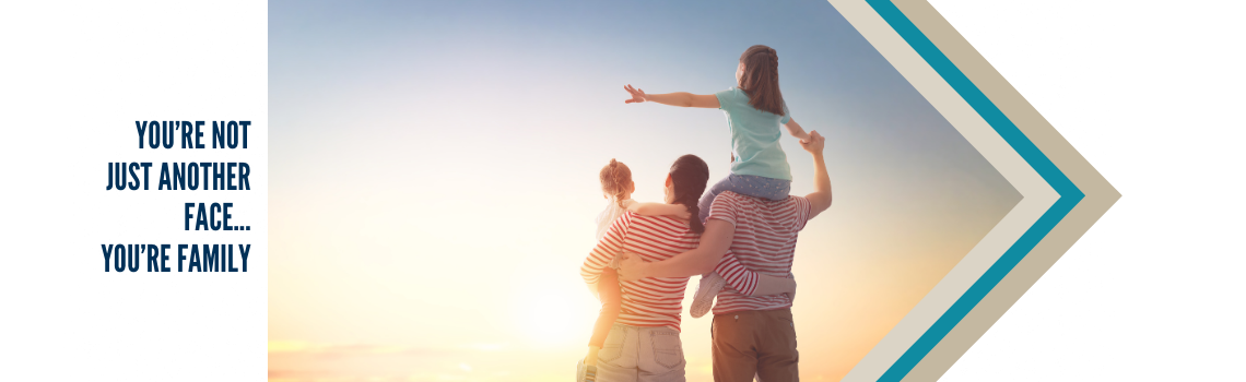 "A family of four, with the parents carrying their children on their shoulders, watching the sunset together. Text on the left reads 'You're not just another face... you are family.'"